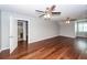 Large main bedroom with a ceiling fan, wood flooring, and an ensuite bathroom at 2001 Baltusrol Ct, Summerville, SC 29483