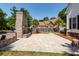 This brick fireplace and patio offer an outdoor living space with a stone patio and lush landscaping at 2001 Baltusrol Ct, Summerville, SC 29483
