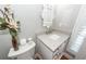 Elegant powder room with granite counters, decorative mirror and modern fixtures at 2001 Baltusrol Ct, Summerville, SC 29483