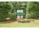 The Pine Forest Country Club sign surrounded by lush bushes and a meticulously manicured lawn at 2001 Baltusrol Ct, Summerville, SC 29483