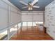 Bright sunroom with hardwood floors, ceiling fan, and lots of natural light at 2001 Baltusrol Ct, Summerville, SC 29483