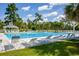 Relaxing view of the community swimming pool with rows of lounge chairs and towering palm trees at 2001 Baltusrol Ct, Summerville, SC 29483
