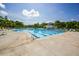 Expansive outdoor swimming pool featuring a gazebo, lounge chairs, and mature trees in the background at 2001 Baltusrol Ct, Summerville, SC 29483