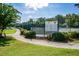 View of the community's tennis courts featuring manicured landscaping and a detailed information board at 2001 Baltusrol Ct, Summerville, SC 29483