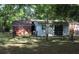 View of the backyard with a structure that has white siding and a brick rear wall at 202 Easy, Goose Creek, SC 29445