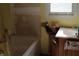 Damaged bathroom shows the plumbing, sink, tub, and window needing repair and renovations at 202 Easy, Goose Creek, SC 29445