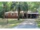 Charming single story home with brick and light-colored siding with a large palm tree in the front yard at 202 Easy, Goose Creek, SC 29445