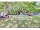 Spacious backyard featuring a charming shed, beautiful landscaping, and ample space for outdoor enjoyment at 2021 Beckton St, North Charleston, SC 29420