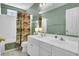 Well-lit bathroom features double sinks, white cabinets, and a shower with patterned curtain at 2021 Beckton St, North Charleston, SC 29420
