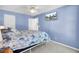 Bright bedroom boasts blue walls and a mounted television for ultimate relaxation at 2021 Beckton St, North Charleston, SC 29420