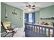 Bright bedroom with chair, striped bedding, ceiling fan, and decorative nautical theme at 2021 Beckton St, North Charleston, SC 29420