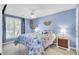 Light and airy bedroom featuring blue walls, a floral comforter, and a ceiling fan at 2021 Beckton St, North Charleston, SC 29420