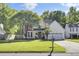 Charming two-story home with well-manicured lawn, mature trees, and attached garage at 2021 Beckton St, North Charleston, SC 29420