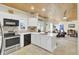 Well-lit kitchen with white cabinets, breakfast bar, and connection to the living room at 2021 Beckton St, North Charleston, SC 29420