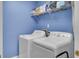 Functional laundry room features a side-by-side washer and dryer and shelving at 2021 Beckton St, North Charleston, SC 29420