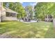Inviting patio area with outdoor dining set and screened porch, overlooking a beautifully maintained backyard at 2021 Beckton St, North Charleston, SC 29420