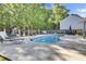 Inviting backyard swimming pool surrounded by ample lounge seating and lush landscaping at 2021 Beckton St, North Charleston, SC 29420