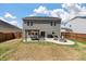 Large backyard with a pergola, dining set, patio, and fire pit area perfect for entertaining guests at 210 Witch Hazel St, Summerville, SC 29486