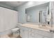 Bright bathroom featuring a white vanity, large mirror, and tub with a shower and white shower curtain at 210 Witch Hazel St, Summerville, SC 29486