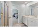 Bright bathroom featuring double sinks with a view into the primary bedroom at 210 Witch Hazel St, Summerville, SC 29486