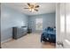 Blue bedroom featuring a ceiling fan, dresser, a window, and a bed with a patterned blanket at 210 Witch Hazel St, Summerville, SC 29486
