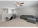 Upstairs bonus room features carpeted floors, a ceiling fan, and a comfortable gray sectional sofa at 210 Witch Hazel St, Summerville, SC 29486