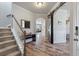 Inviting entryway with hardwood floors, staircase, and an arched doorway at 210 Witch Hazel St, Summerville, SC 29486