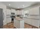 Bright kitchen featuring white cabinets, granite countertops, stainless steel appliances, and hardwood floors at 210 Witch Hazel St, Summerville, SC 29486