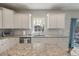 Well-designed kitchen features white cabinets, granite countertops, and stainless steel appliances at 210 Witch Hazel St, Summerville, SC 29486
