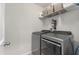 Well-equipped laundry room with modern gray washer and dryer and storage shelves for convenience at 210 Witch Hazel St, Summerville, SC 29486