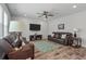 Spacious living room with hard floors, two leather sofas, a ceiling fan, and a mounted TV at 210 Witch Hazel St, Summerville, SC 29486