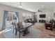 Spacious living area combines dining and relaxation with hardwood floors, a fan, and plenty of light at 210 Witch Hazel St, Summerville, SC 29486