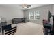 Neutral living room features a gray sectional, ceiling fan and a large window for ample natural light at 210 Witch Hazel St, Summerville, SC 29486