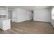 Spacious living area with wood-look flooring flowing into the kitchen and staircase visible at 211 W Bradford Pointe Dr Dr, Summerville, SC 29483
