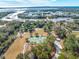 Beautiful aerial view showcasing tennis courts and lush green spaces, surrounded by mature trees at 2138 Boatwright Rd, Johns Island, SC 29455