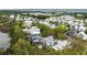 An aerial view showing a home surrounded by lush greenery and a serene lake at 2138 Boatwright Rd, Johns Island, SC 29455
