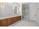 Luxurious bathroom with wood cabinets, double vanity, marble floors, and glass-enclosed shower at 2138 Boatwright Rd, Johns Island, SC 29455