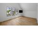 Sunlit bedroom features hardwood floors and large windows framing views of nearby homes at 2138 Boatwright Rd, Johns Island, SC 29455