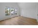 Sunlit bedroom showcases wood floors and large windows framing views of nearby homes at 2138 Boatwright Rd, Johns Island, SC 29455