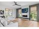 Bright living room featuring a sleek fireplace, hardwood floors, and natural light from large windows at 2138 Boatwright Rd, Johns Island, SC 29455