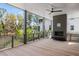 Wide porch area featuring outdoor fireplace, ceiling fan, and view of wooded yard at 2138 Boatwright Rd, Johns Island, SC 29455