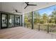 Spacious covered outdoor patio featuring a ceiling fan and view of a wooded area at 2138 Boatwright Rd, Johns Island, SC 29455