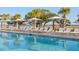 Relaxing pool area with lounge chairs and umbrellas, ideal for leisurely afternoons at 2138 Boatwright Rd, Johns Island, SC 29455