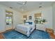 Bright bedroom featuring a cozy queen bed, blue accents, and a door to a private outdoor area at 22 Fairhope Rd, Mount Pleasant, SC 29464