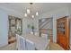 Elegant dining room with modern lighting, seating for six, and access to the living room at 22 Fairhope Rd, Mount Pleasant, SC 29464