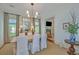 Bright dining room with large windows, stylish decor, and access to the living room and kitchen at 22 Fairhope Rd, Mount Pleasant, SC 29464