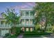 Stunning three-story home with a charming facade and lush landscaping at 22 Fairhope Rd, Mount Pleasant, SC 29464