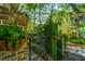 Wrought iron gate surrounded by lush landscaping and a brick wall at 22 Fairhope Rd, Mount Pleasant, SC 29464