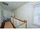 Bright upstairs hallway features hardwood floors, white walls, decorative molding, and natural light at 22 Fairhope Rd, Mount Pleasant, SC 29464