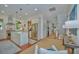Open kitchen featuring stainless appliances, large island, and hardwood floors flowing into living area at 22 Fairhope Rd, Mount Pleasant, SC 29464